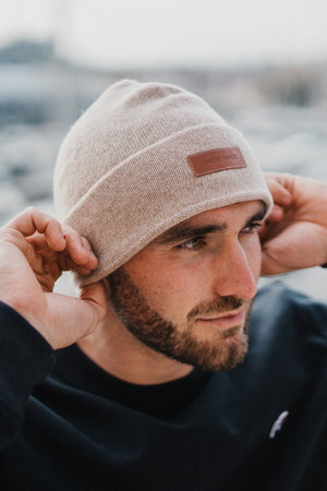 Bonnet en laine bleu marine — porté de face, étiquette cuir, tricoteté en Haute-Loire